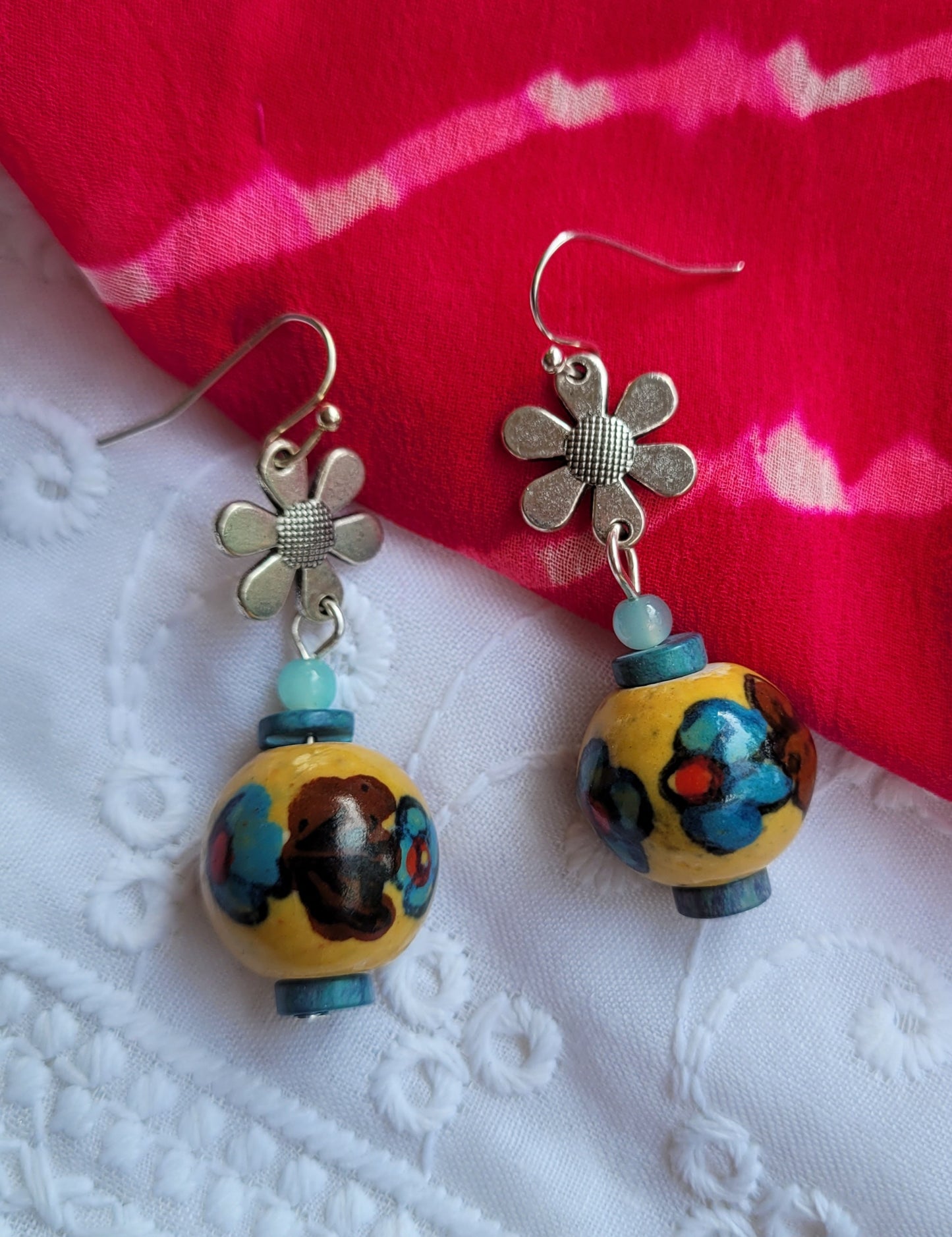 Earrings with floral designs and colorful beads
