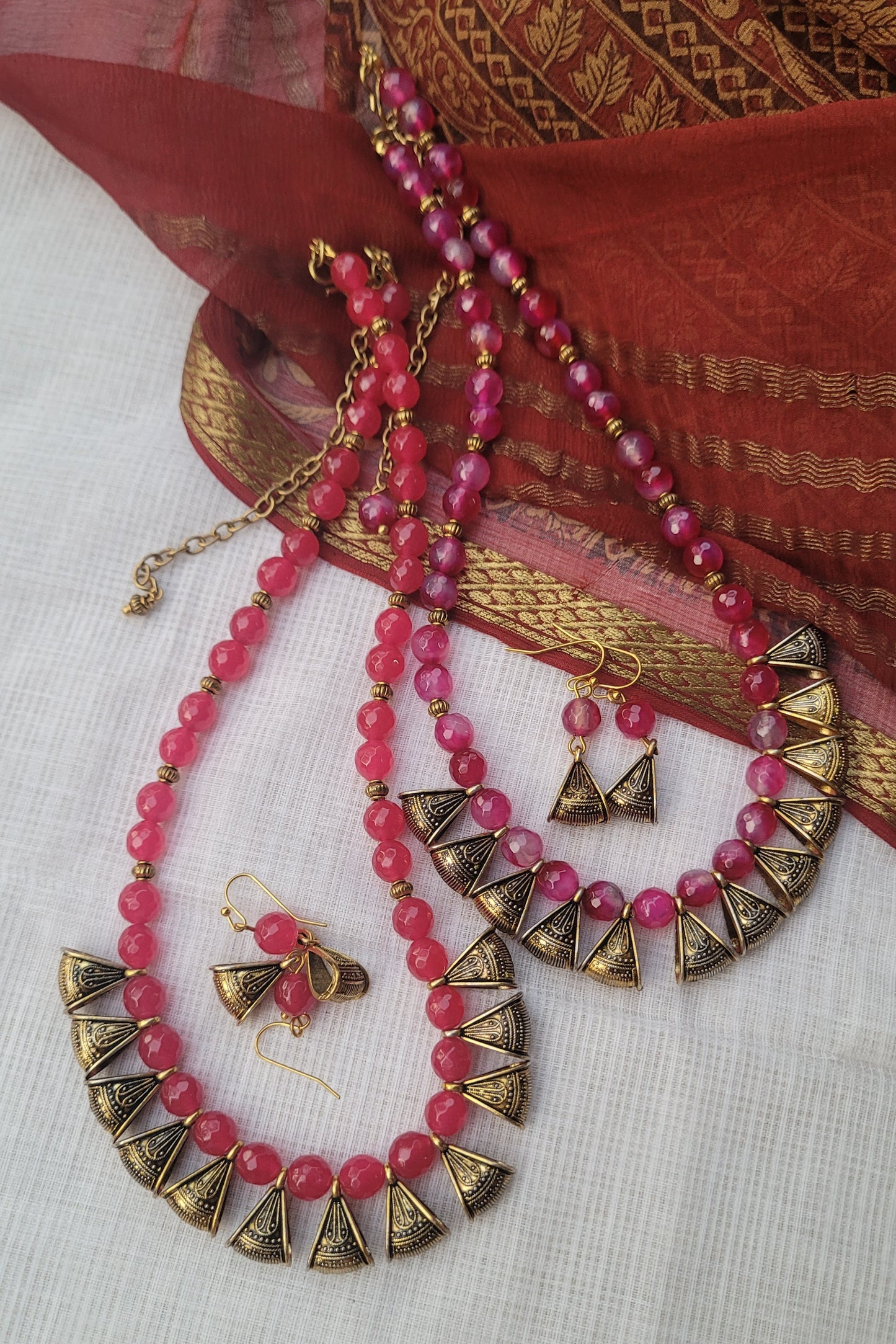 Pink beaded necklace with gold accents