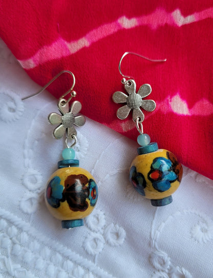 Earrings with floral designs and colorful beads 