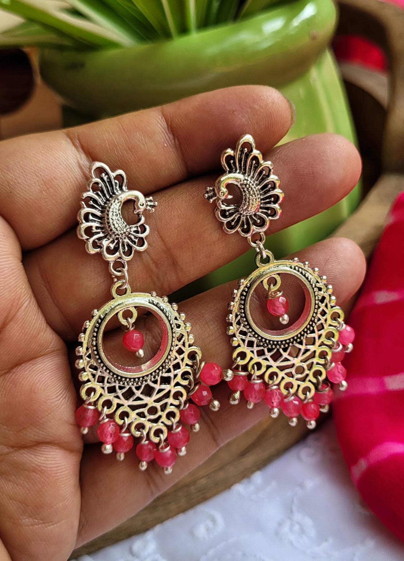Ornate earrings with pink beads