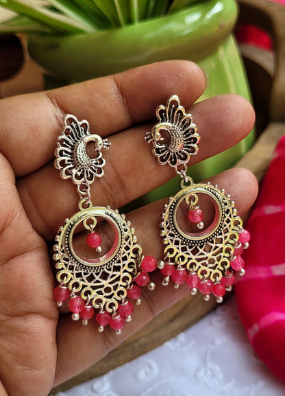 Ornate earrings with pink beads