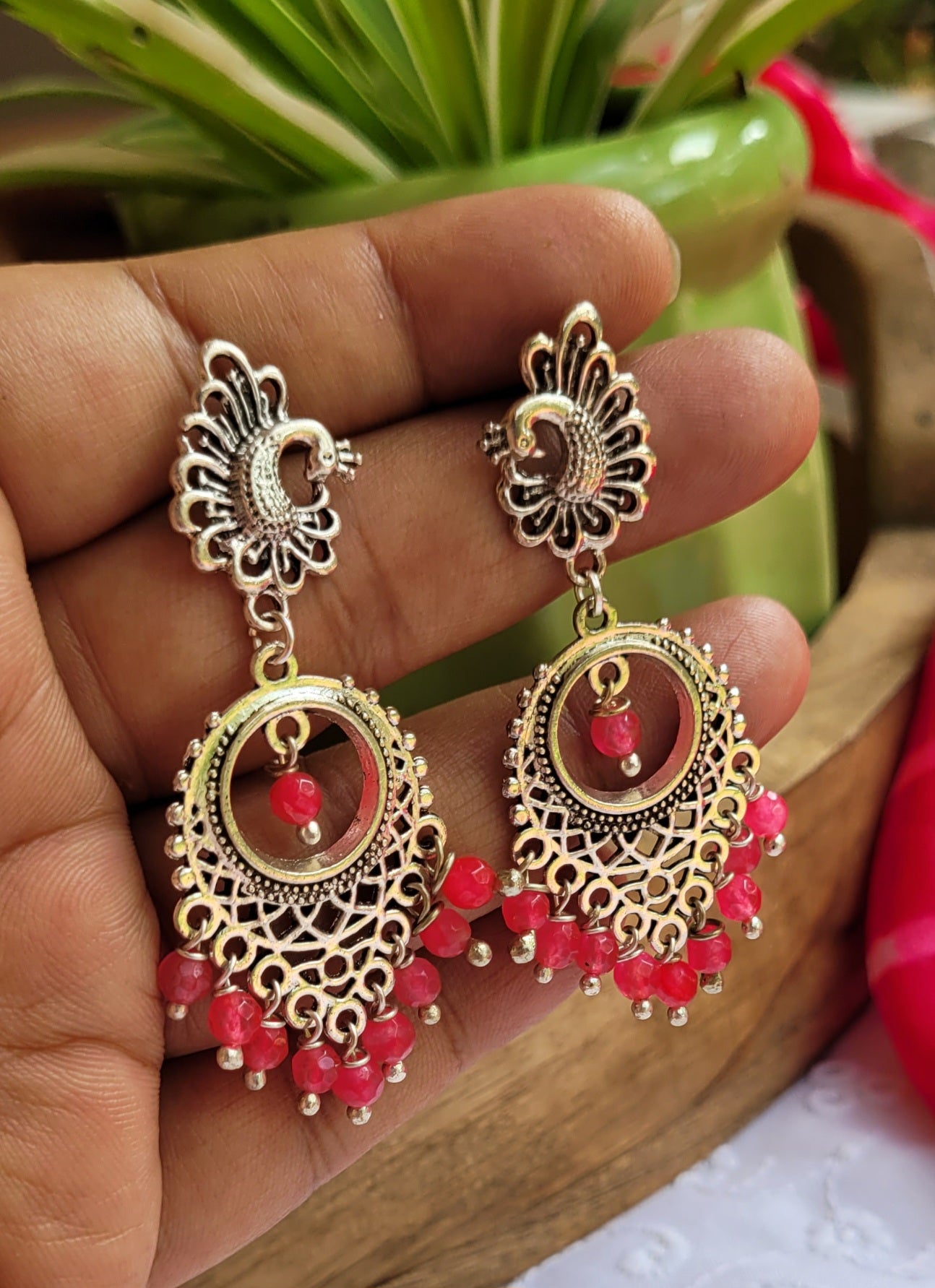 Ornate silver earrings with pink beads