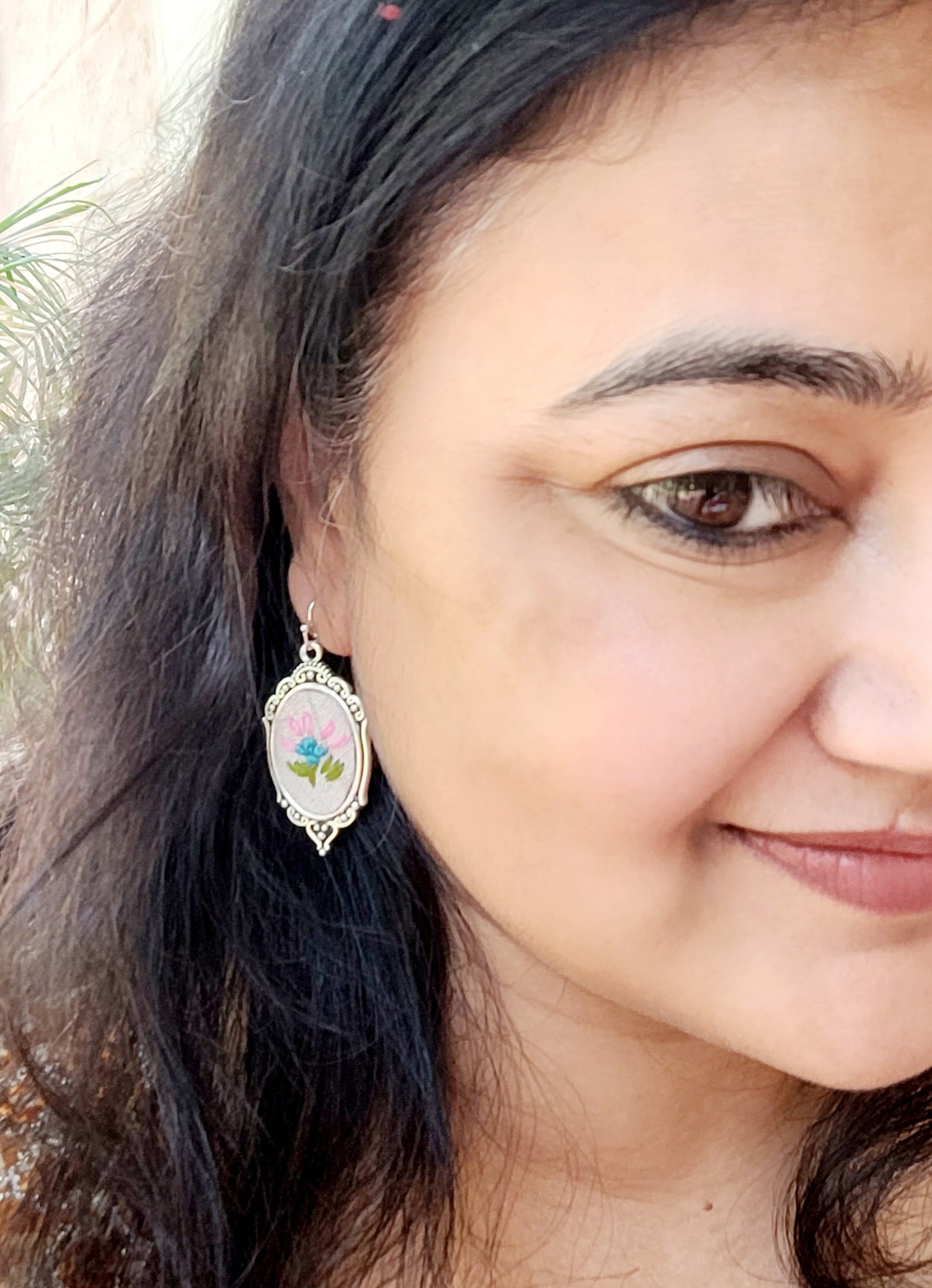 earring with a floral design.
