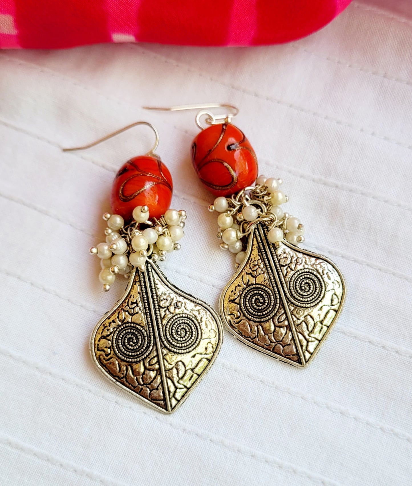Ornate earrings with red beads and pearls