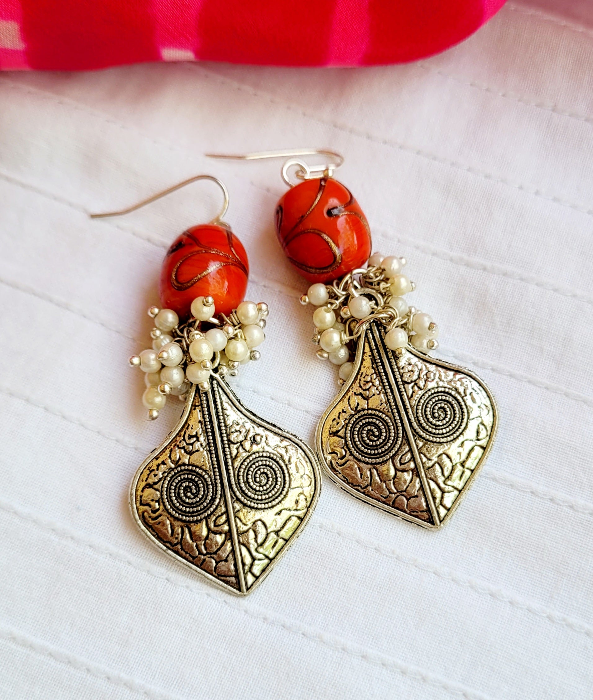 Ornate earrings with red beads and pearls