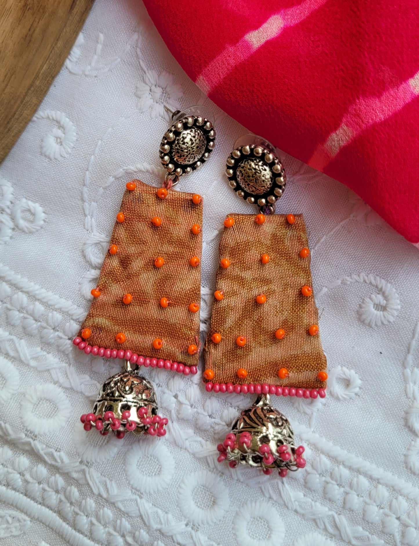 Decorative earrings with orange and pink accents 