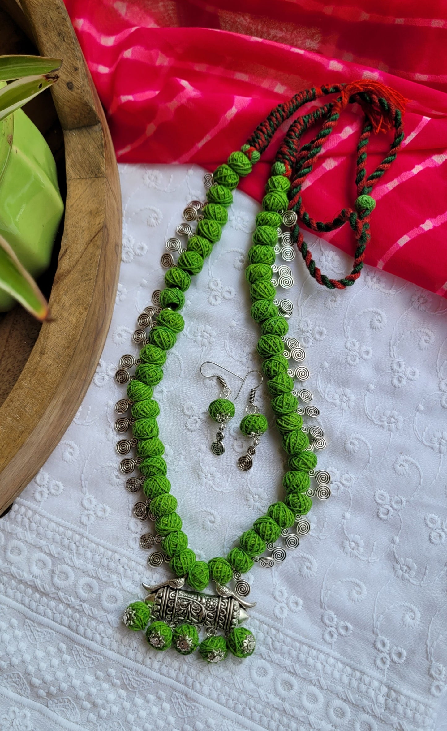 Green necklace with silver pendant 