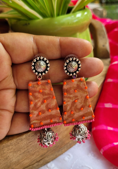 Earrings with orange and pink details and silver studs