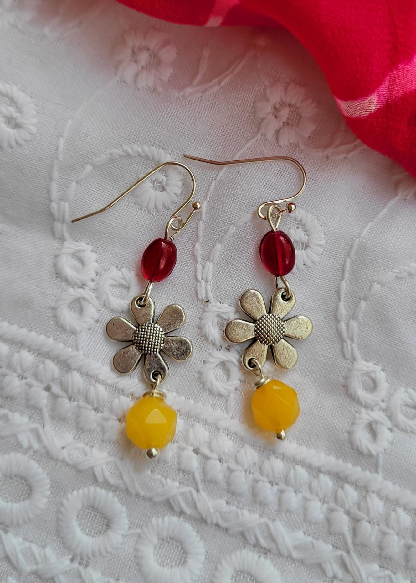 Pair of earrings with floral designs and red and yellow beads 