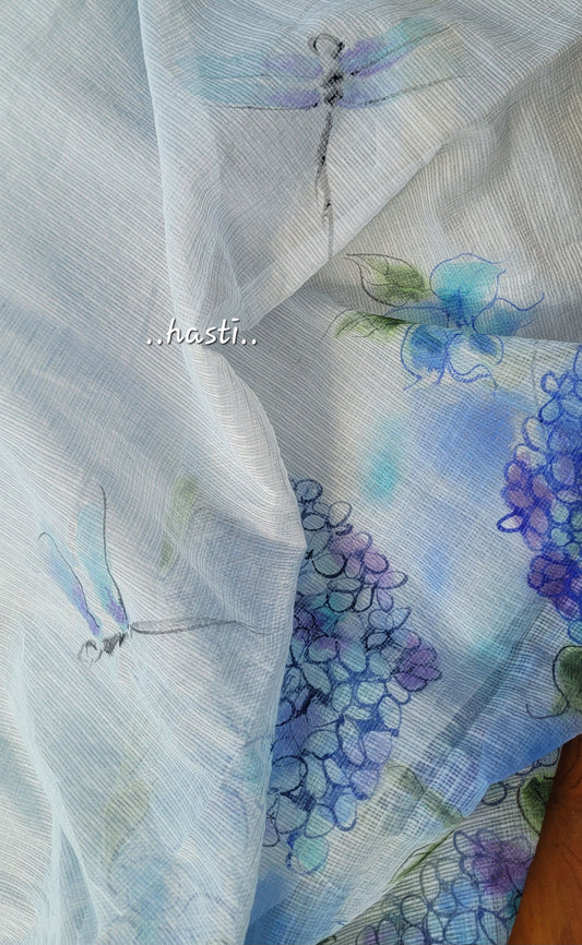 Sheer fabric with floral and dragonfly patterns in blue and purple.