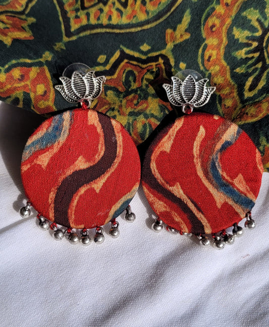 Pair of red fabric earrings with silver accents